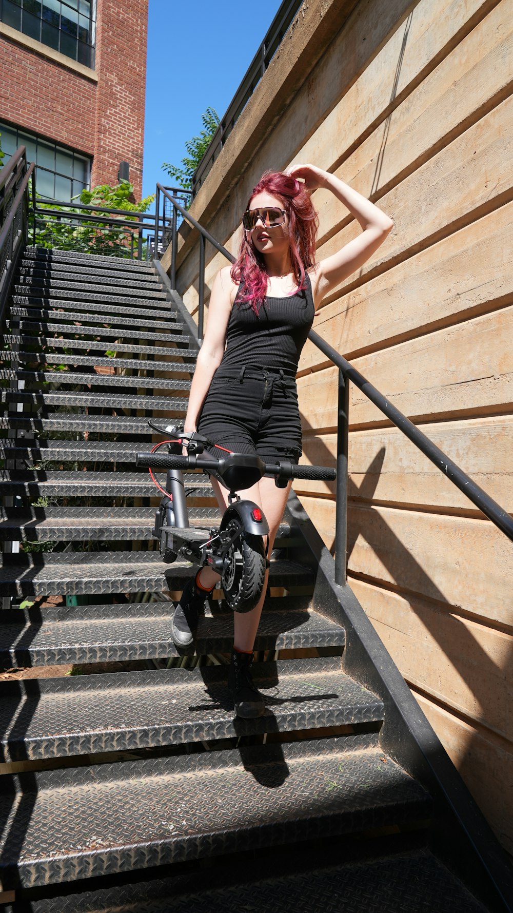 a person standing on a set of stairs with a bike