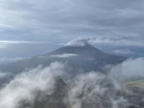 Snow-capped Volcán Sollipulli towering over a rugged landscape at sunrise.