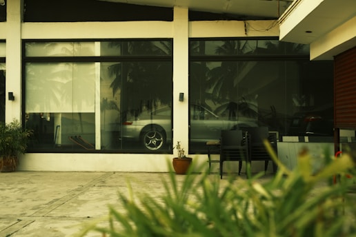 A freshly installed windshield on a vehicle parked outside the Coral Gables auto glass shop.