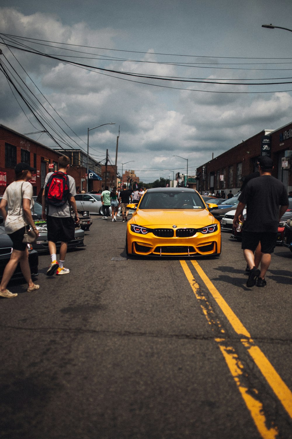 a yellow sports car on a street