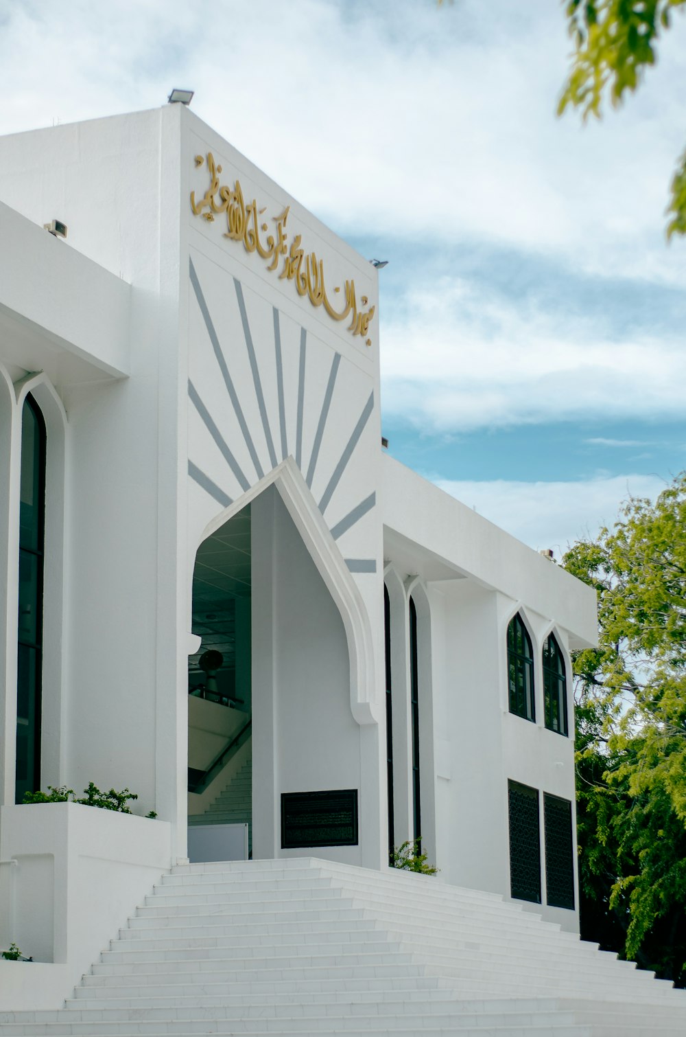 a white building with a gold sign