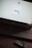 A laptop displaying a WordPress login screen with fields for username and password. The screen has options to log in with Telegram or email. The logo of WordPress is visible on top. A smartphone is resting on the surface near the laptop.