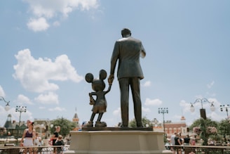 Walt Disney and Mickey Mouse Partners statue at Disney World - symbolic of family Disney vacations f