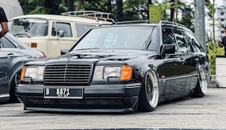 A luxury sedan and a spacious van parked side by side in a serene suburban street.