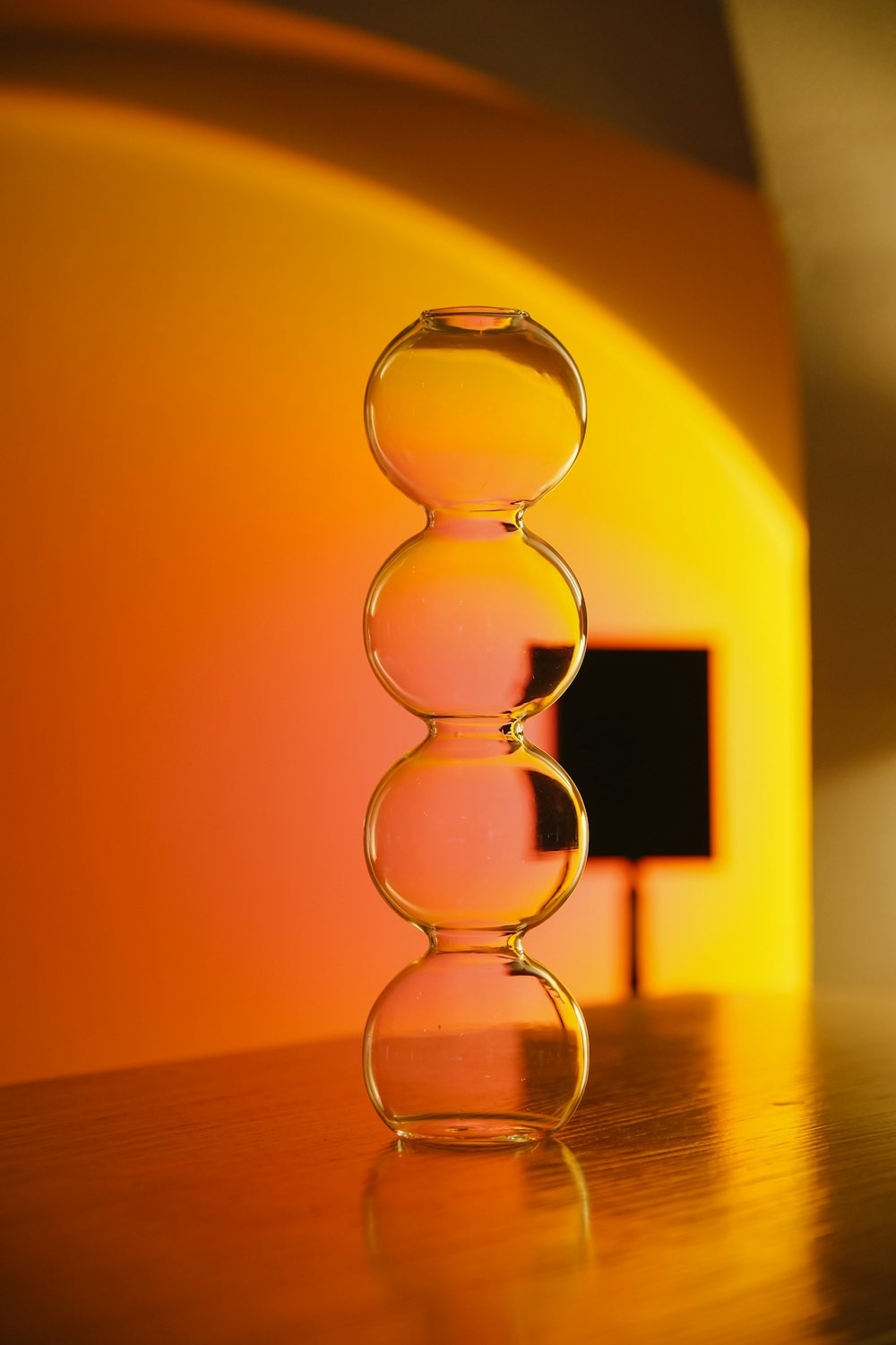 a glass vase with a pink liquid