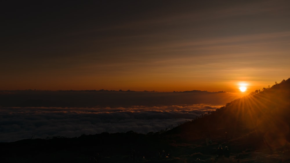 a sunset over a mountain range