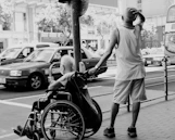 a man pushing a man in a wheelchair