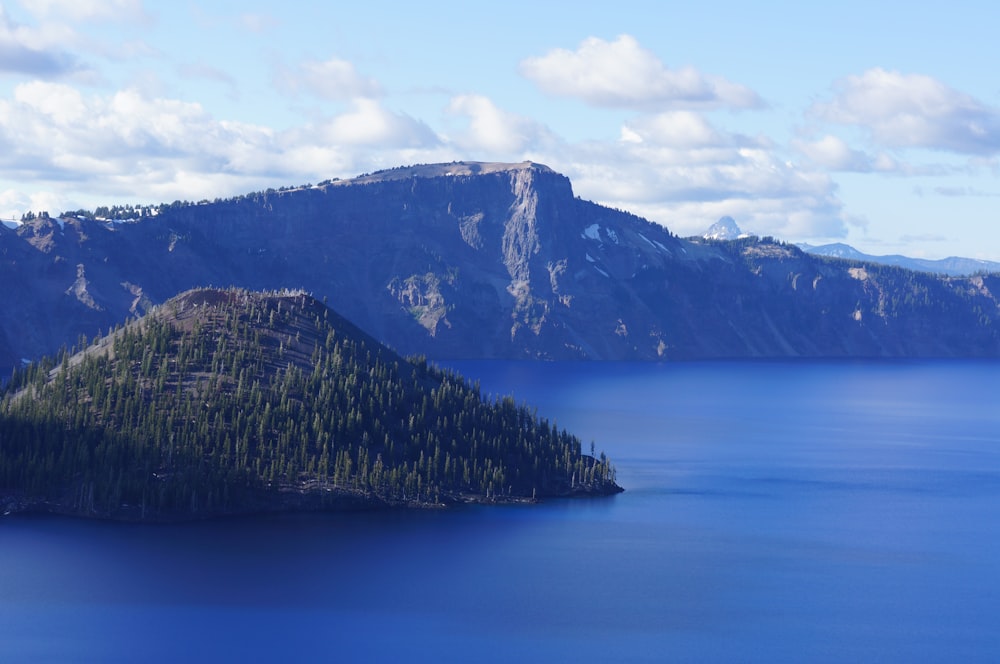 a body of water with mountains in the back