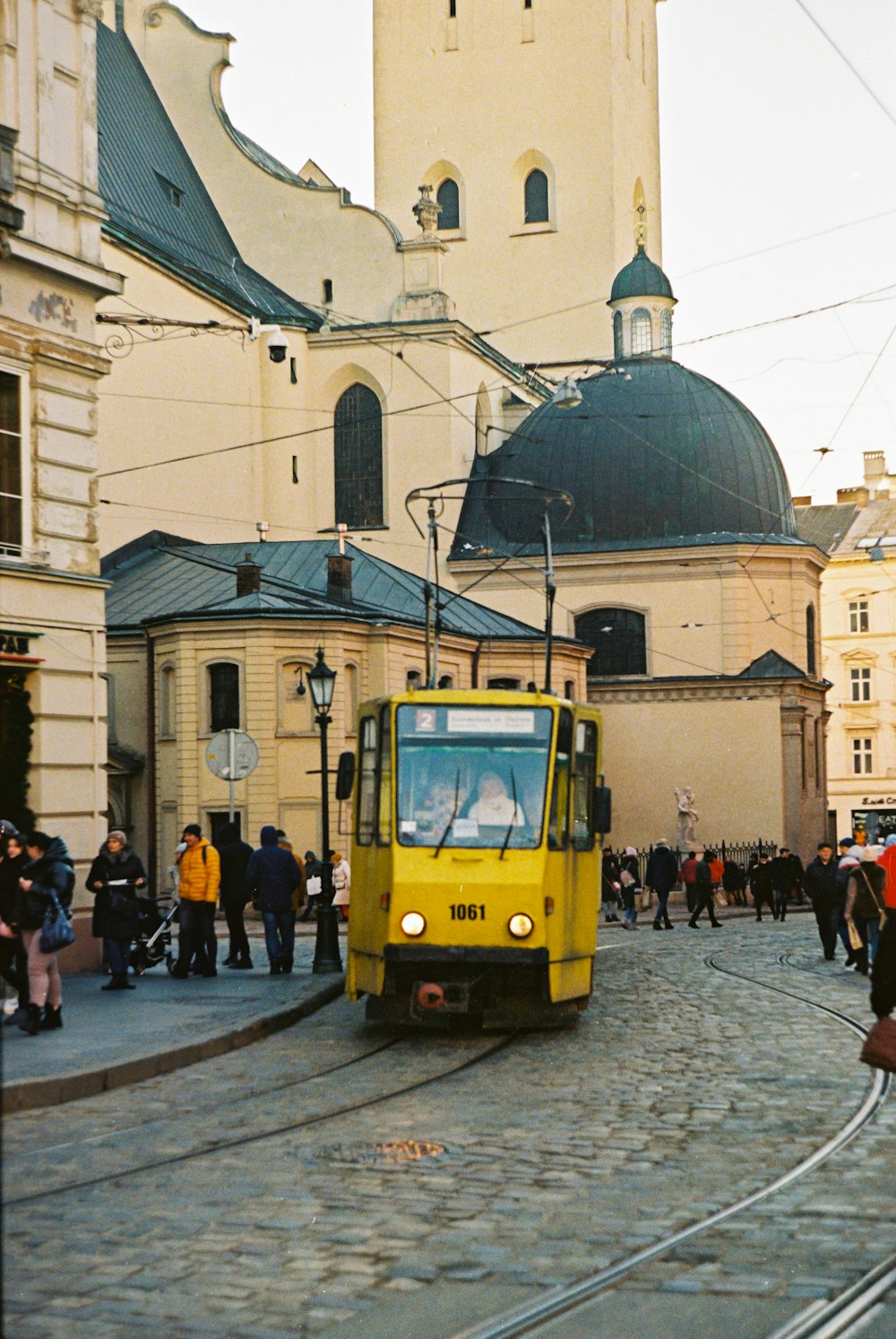 a yellow train on the tracks