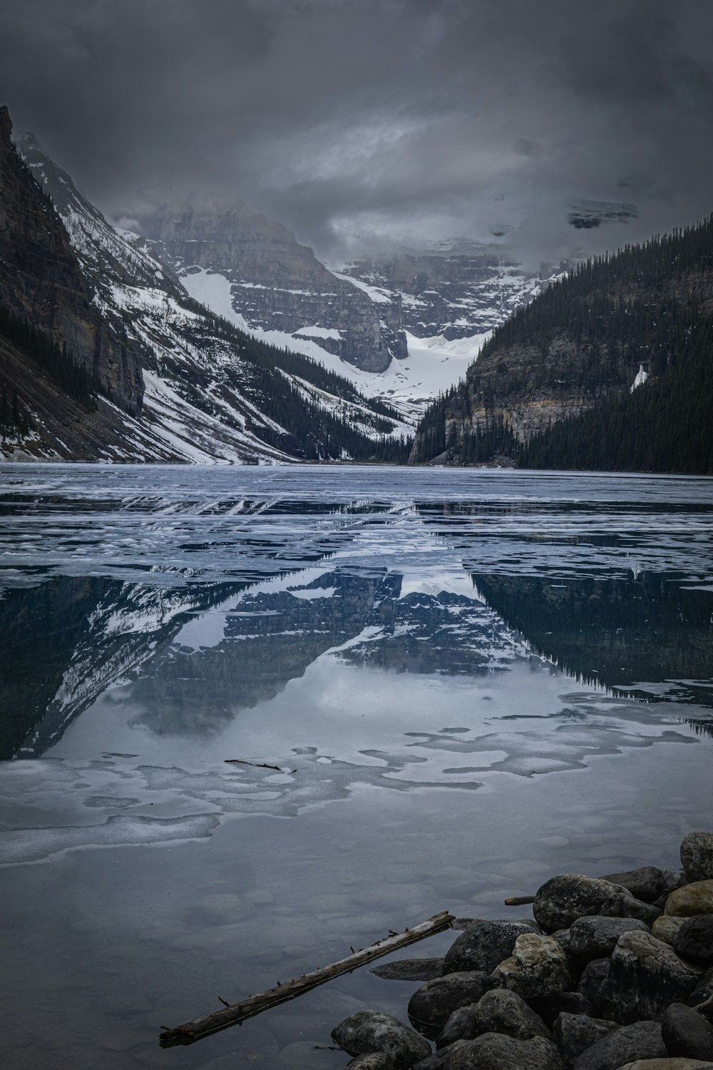 a body of water with mountains in the back