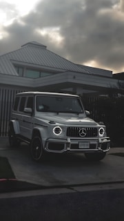 Premium SUV parked in front of a high-end rental house at sunset.