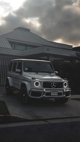 Premium SUV parked in front of a high-end rental house at sunset.