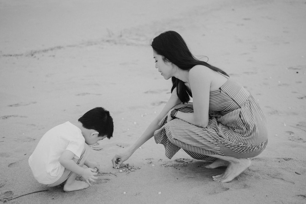 a person and a child playing in the sand