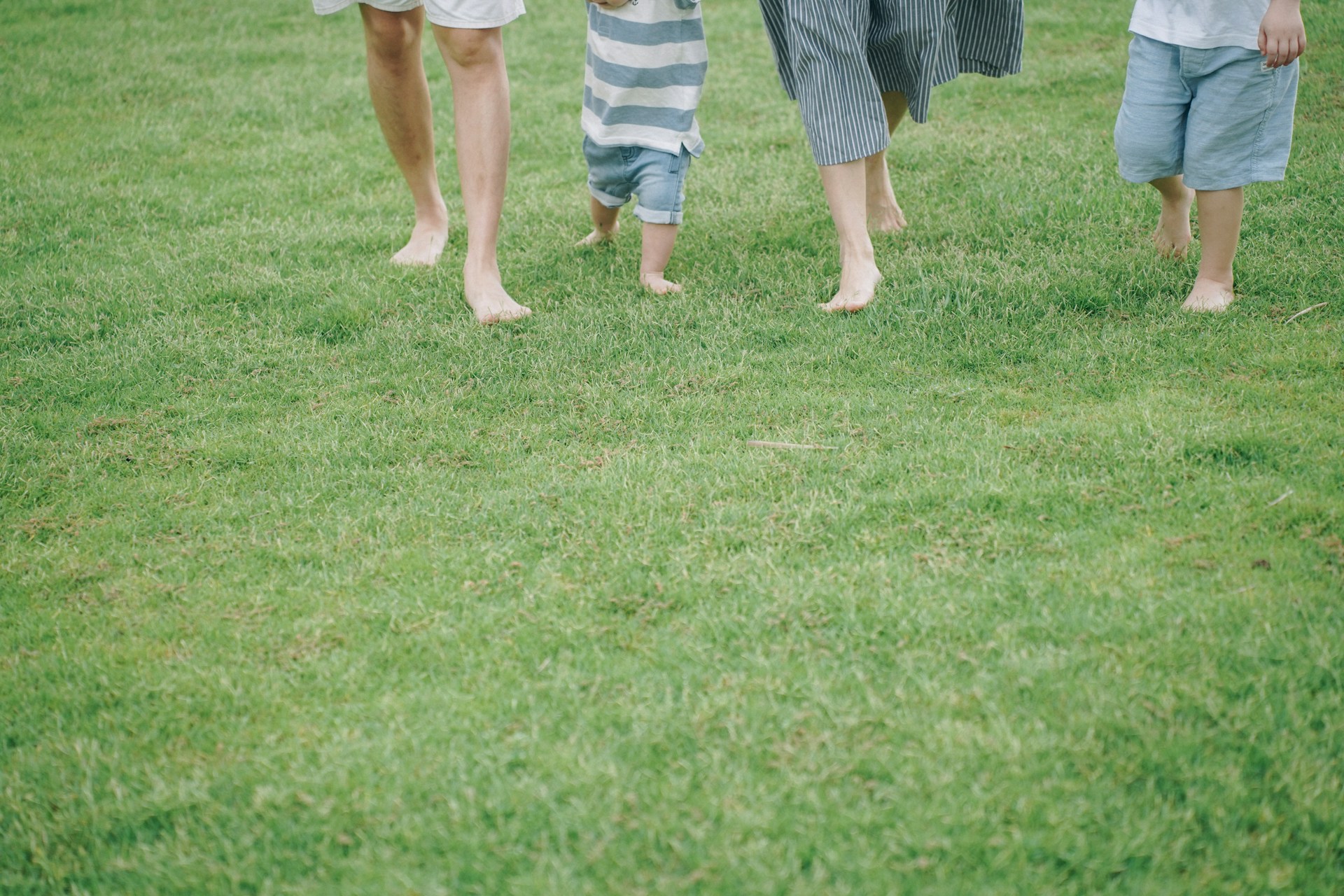 a group of people walking on grass