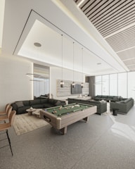 a room with a pool table and couches