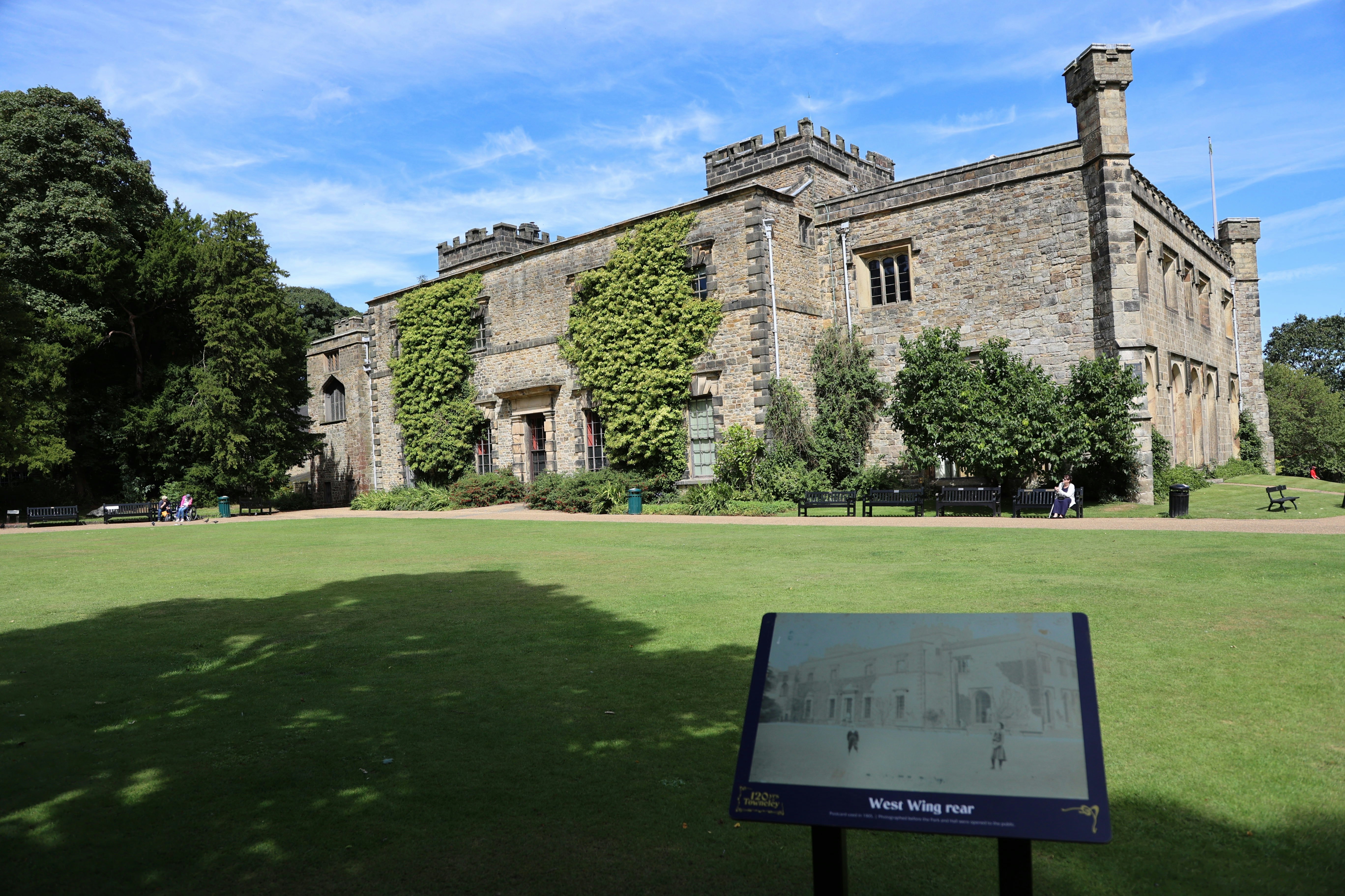 A large stone building with a sign in front of it photo – Free Burnley ...