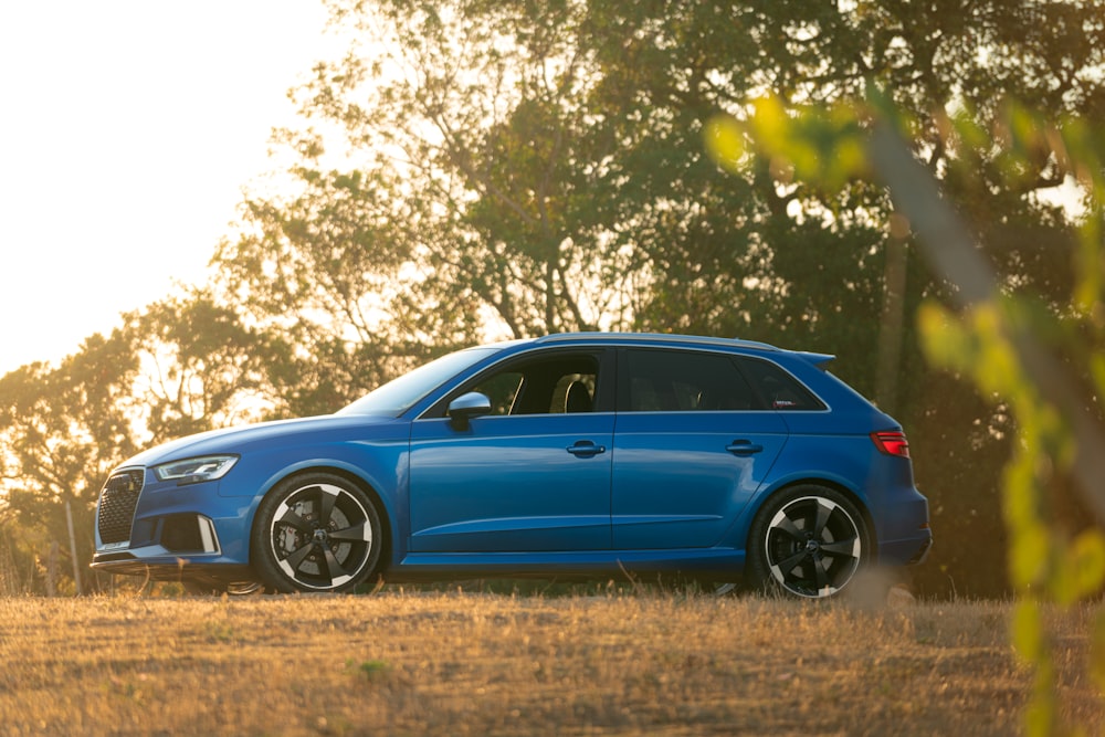 a blue car parked in a field