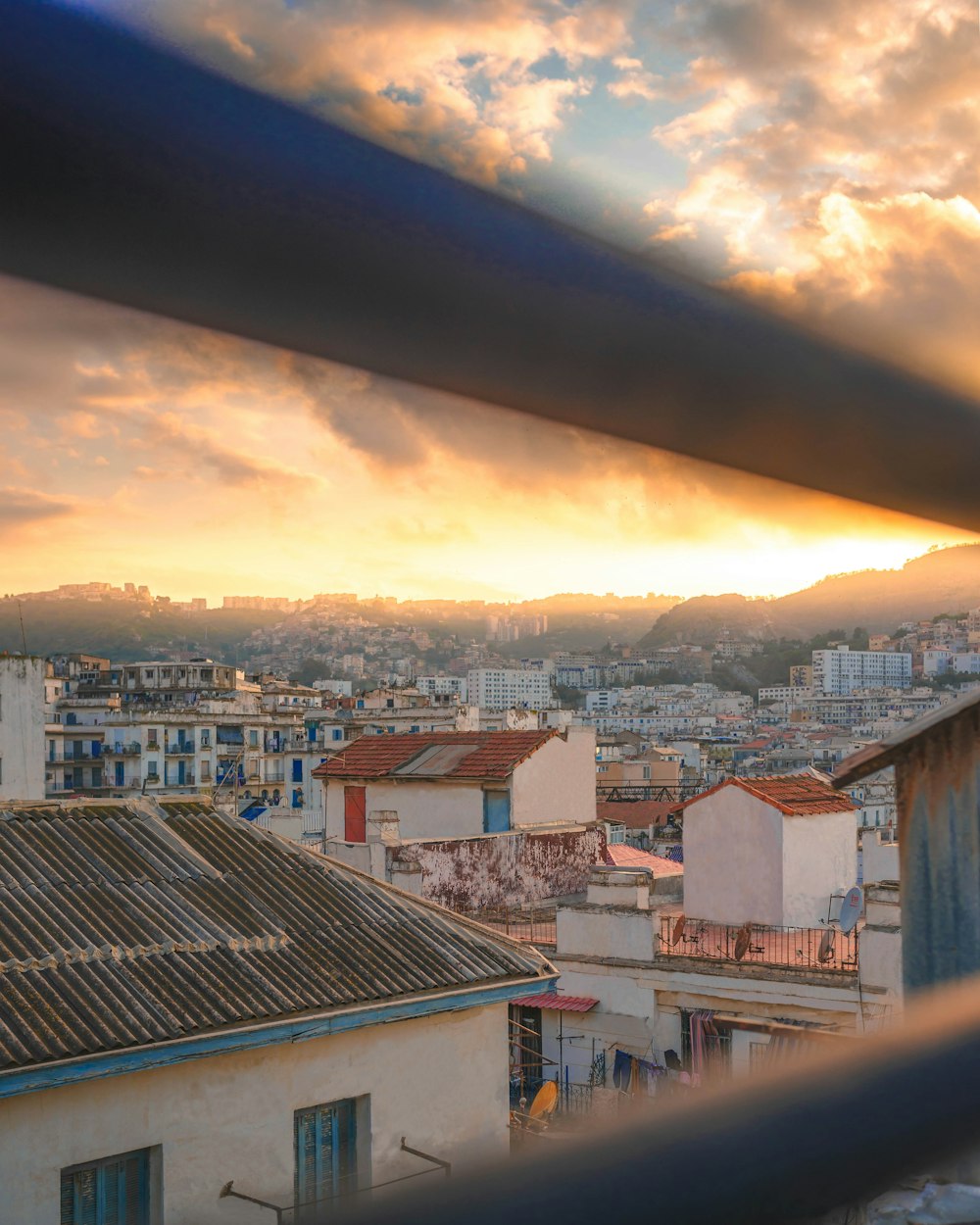 a city with buildings and a sunset