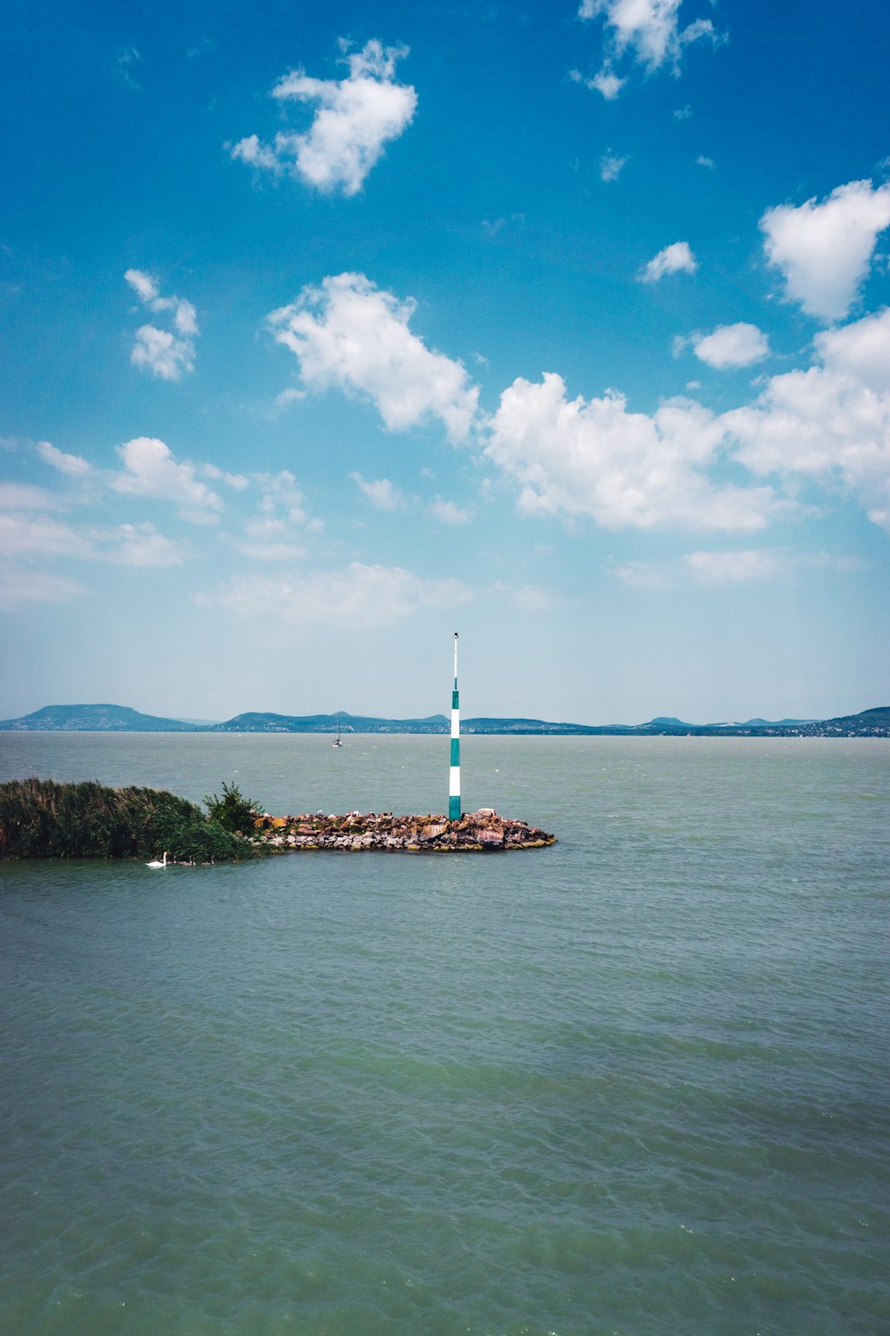 a small island with a sailboat