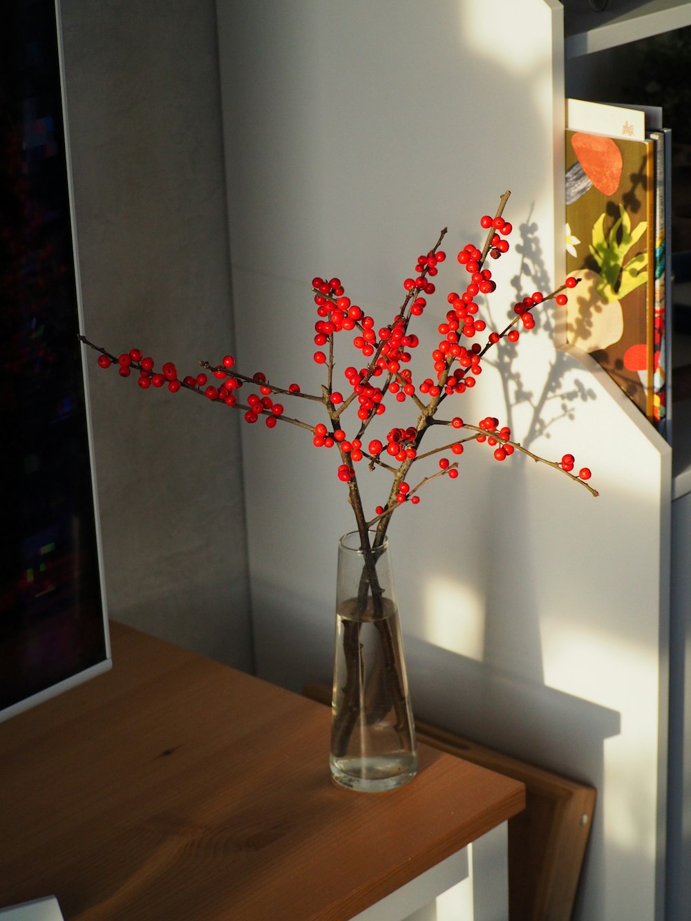 a vase with red flowers