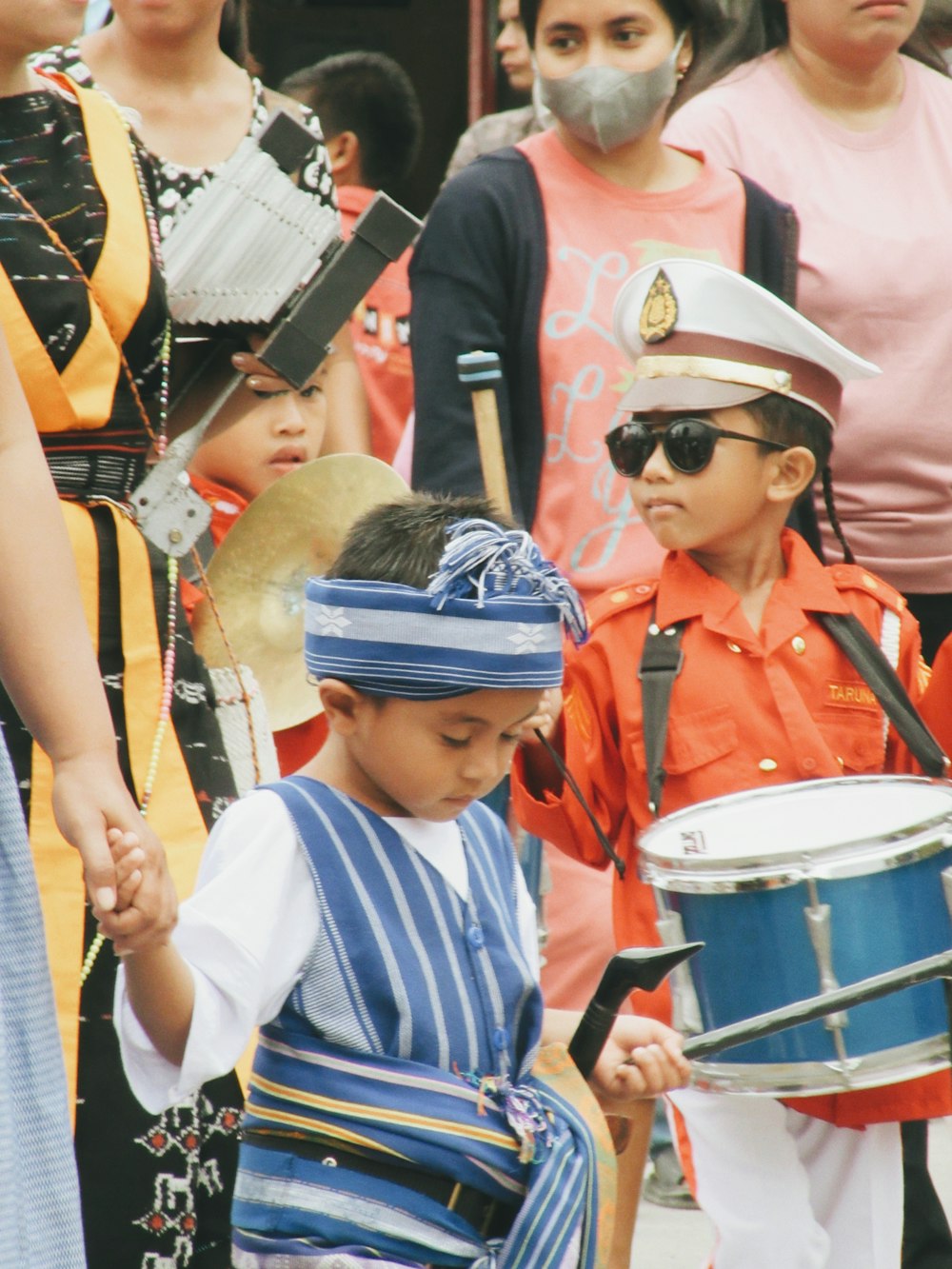 a boy playing drums with a person