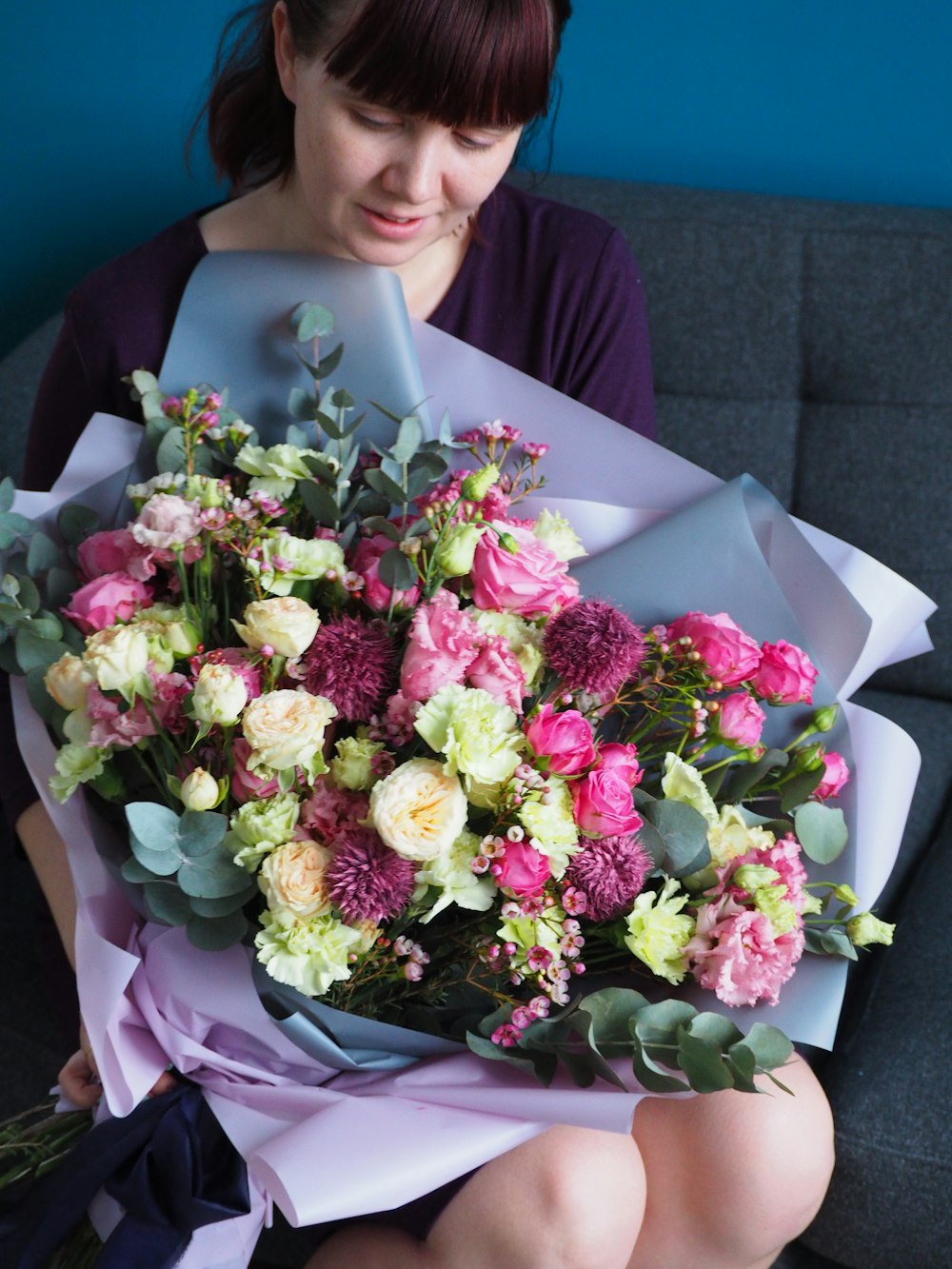 a woman holding a bouquet of flowers