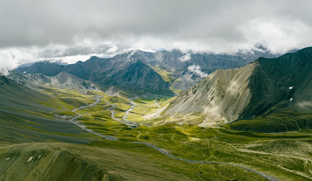 a valley with mountains in the background