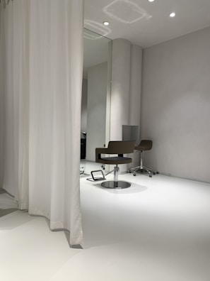 A large wall mirror reflecting a bright, airy space with minimalist decor.