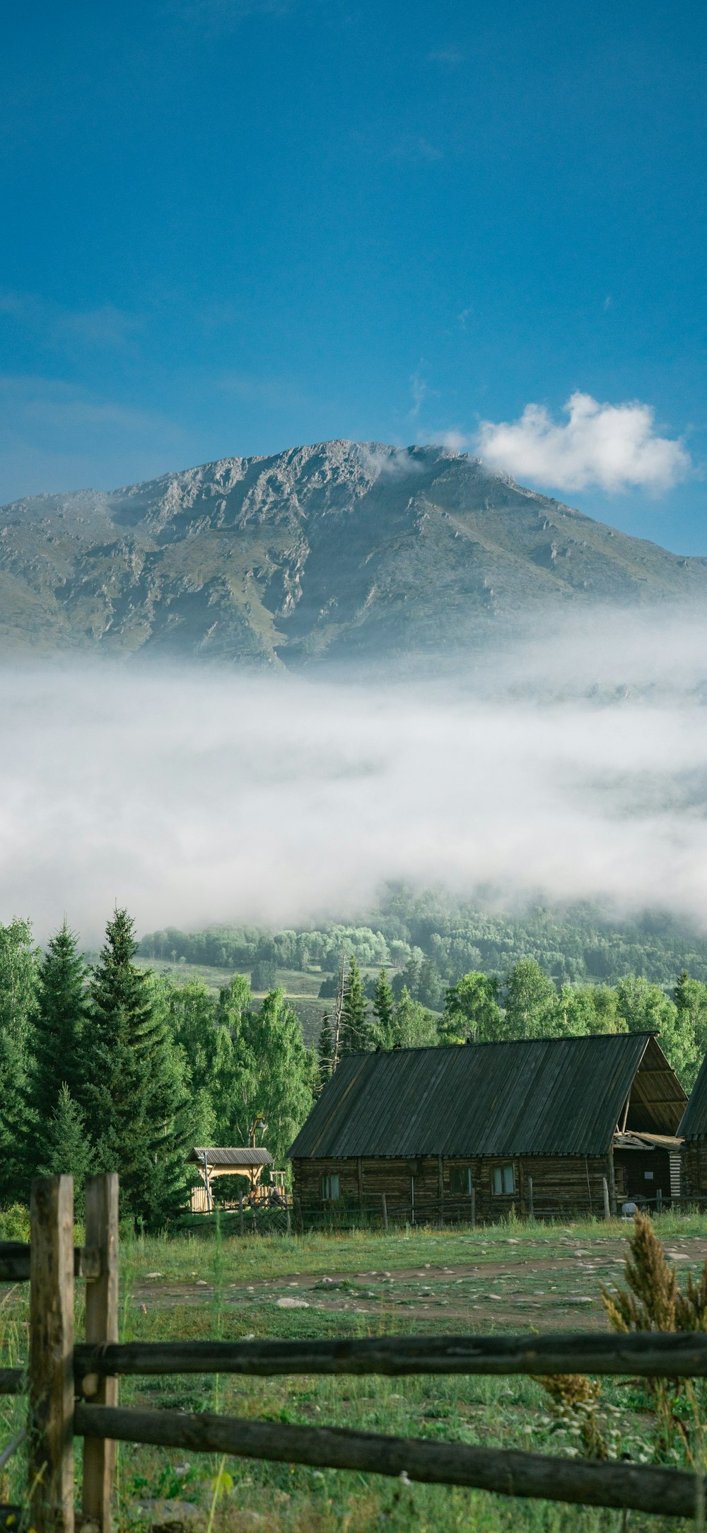 a wooden house in front of a mountain