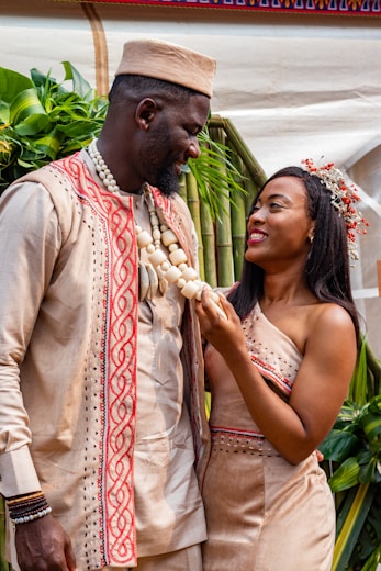 a man and woman holding bananas
