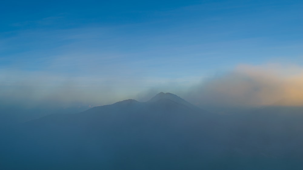 a mountain with clouds