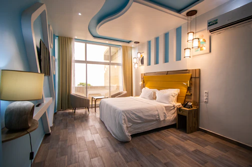 Modern bedroom featuring blue and yellow tones with a view of the Andes.