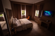 a hotel room with a tv and bed