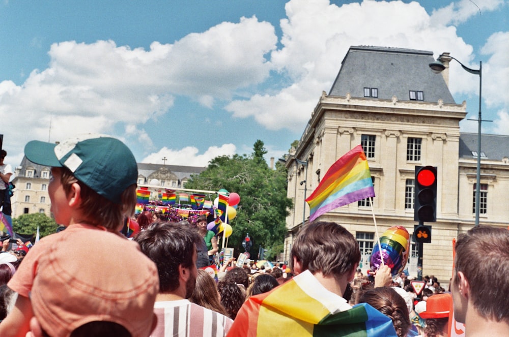 a crowd of people gather at a traffic light