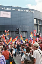 A vibrant demonstration with French flags waving alongside a map of Guadeloupe, symbolizing unity and advocacy.
