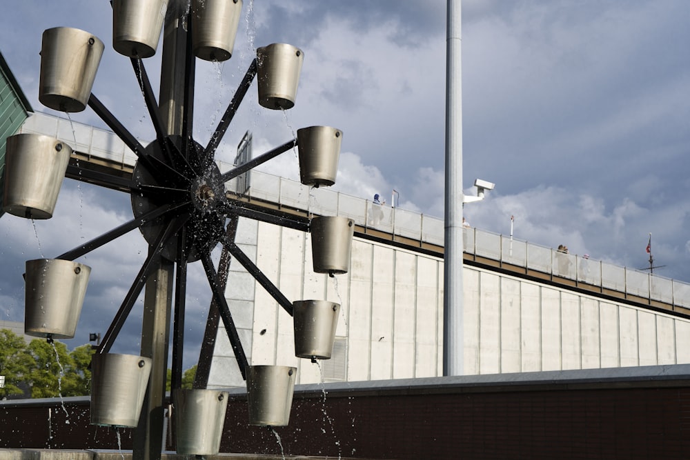 a group of light poles with a bridge in the background