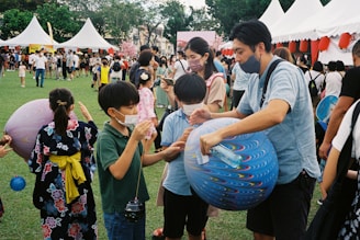 a group of people playing with a blue ball