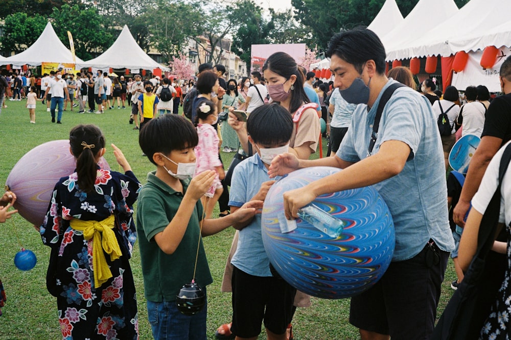 a group of people playing with a blue ball