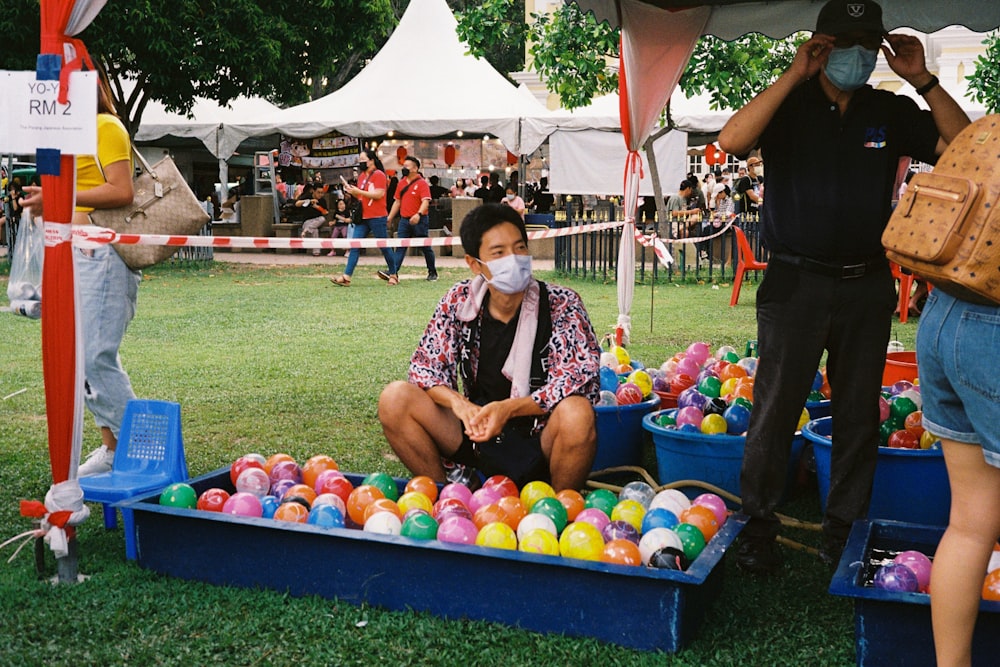 a woman sitting in a ball pit