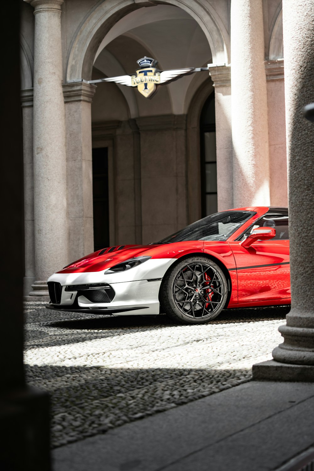 a red sports car parked in front of a building