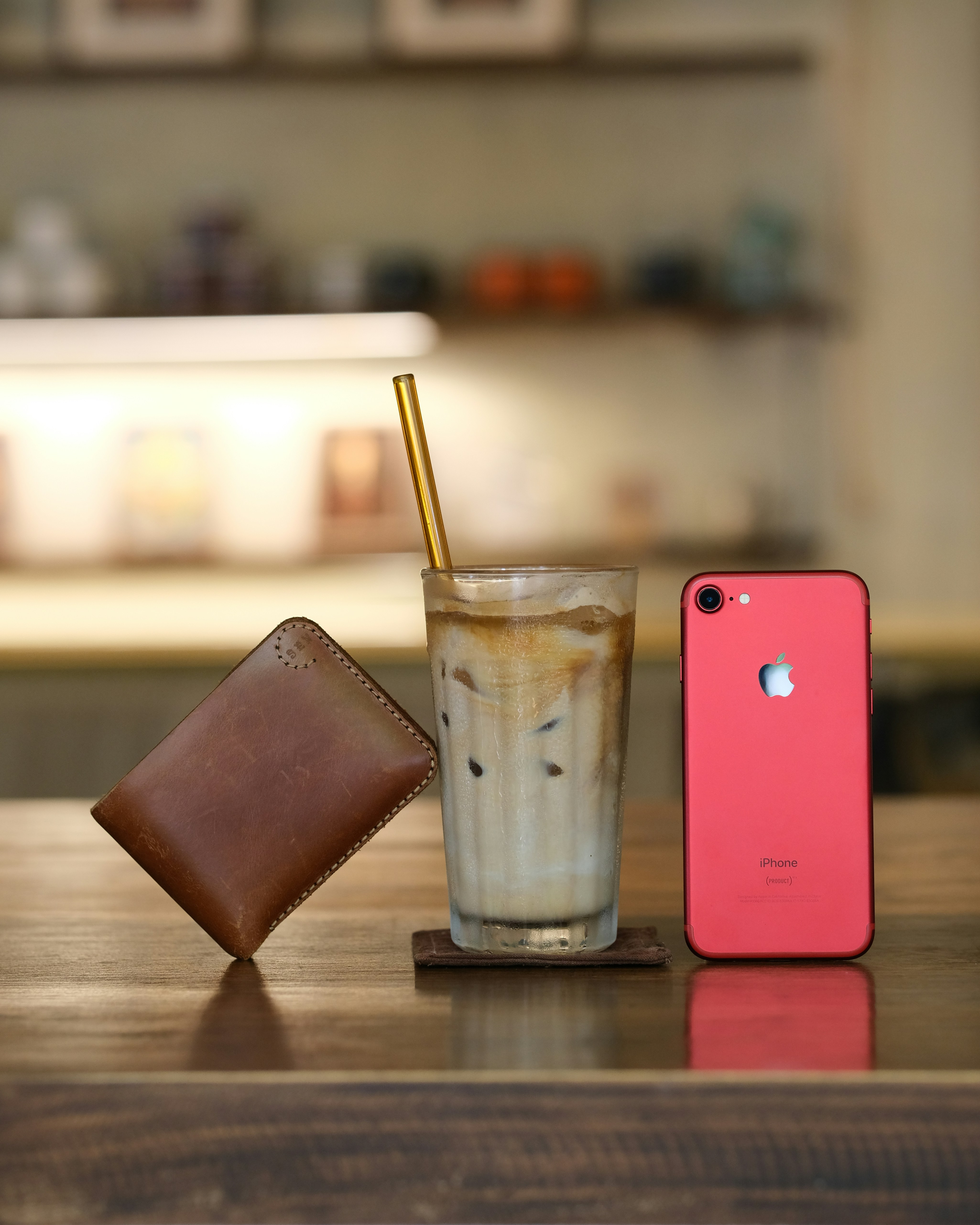 a glass of milk and a cell phone on a table