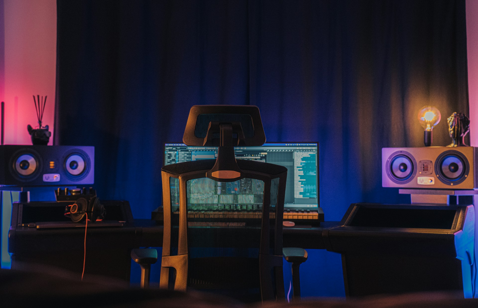 a room with a desk and speakers