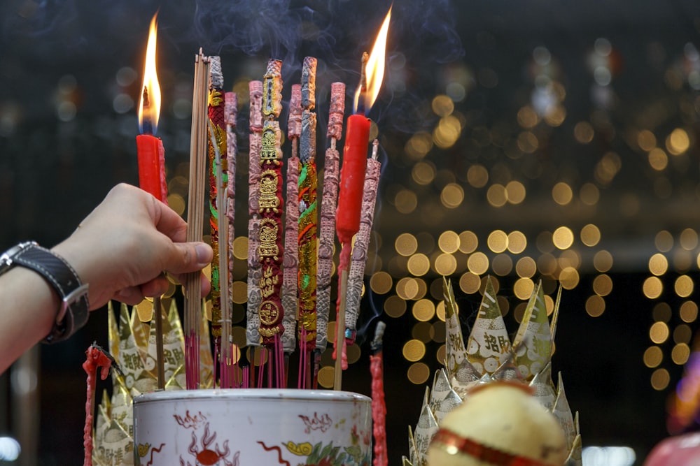 a person lighting candles