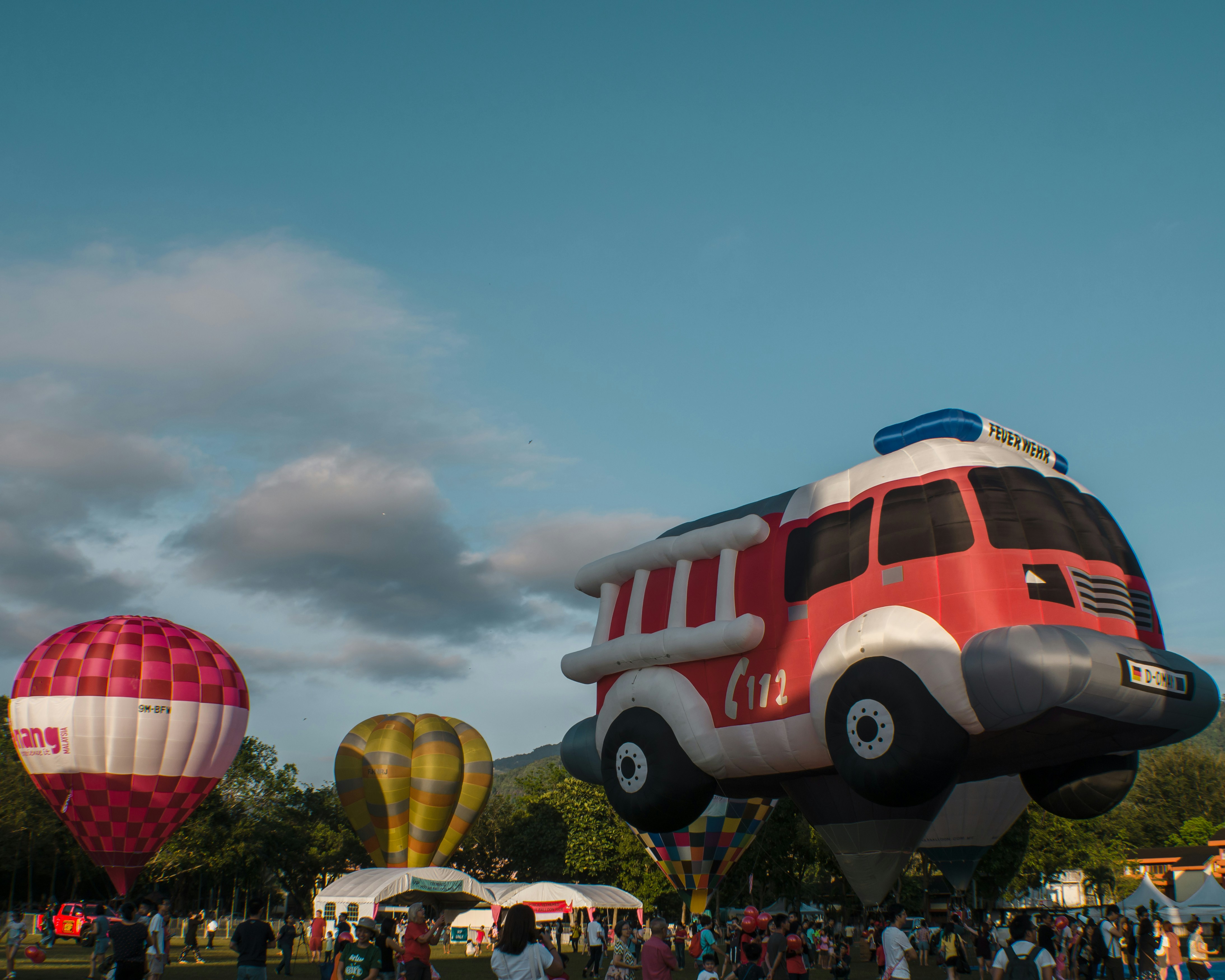 a group of people watching a hot air balloon