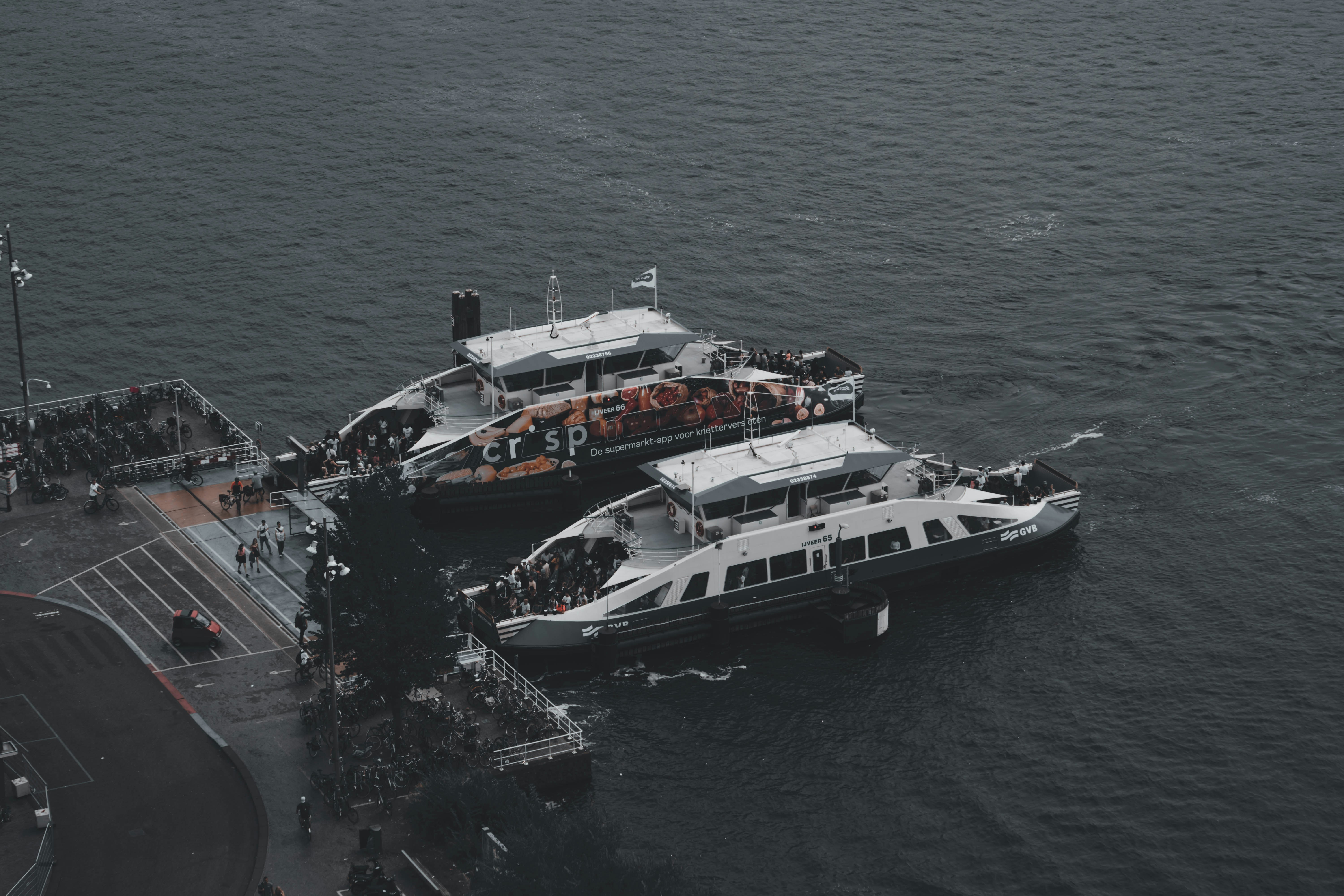 a couple of boats in the water, Ferry Amsterdam Central Station