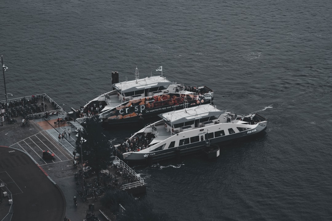 a couple of boats in the water, Ferry Amsterdam Central Station
