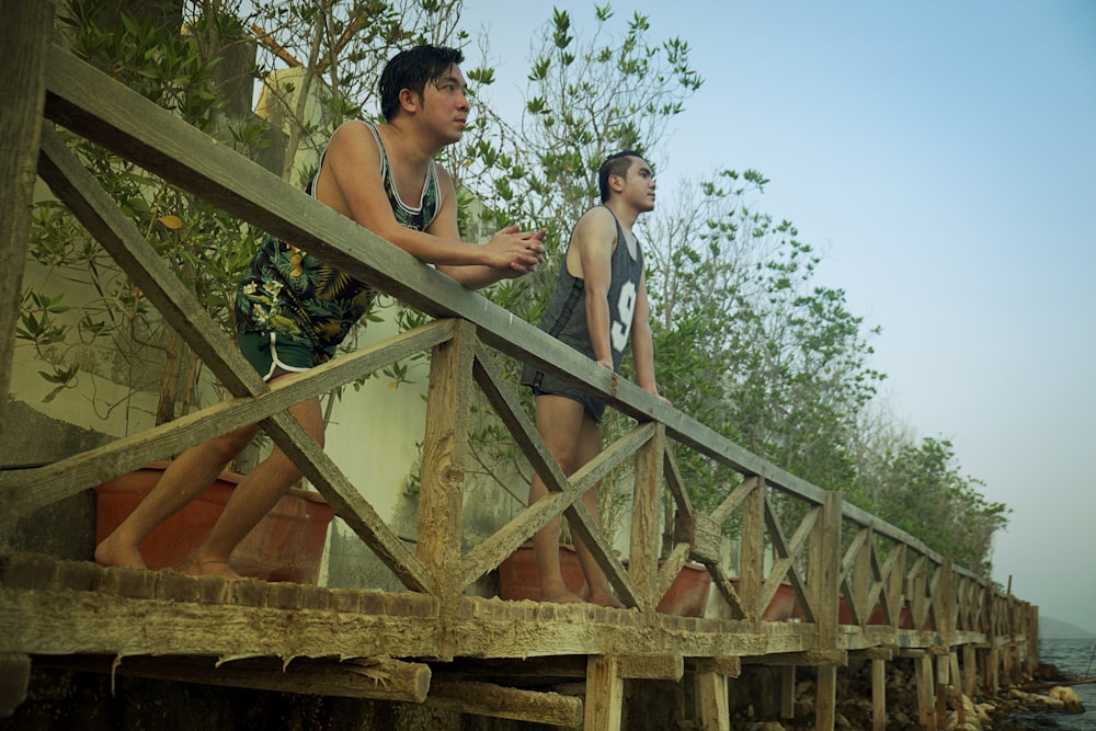 a couple of people on a wooden structure