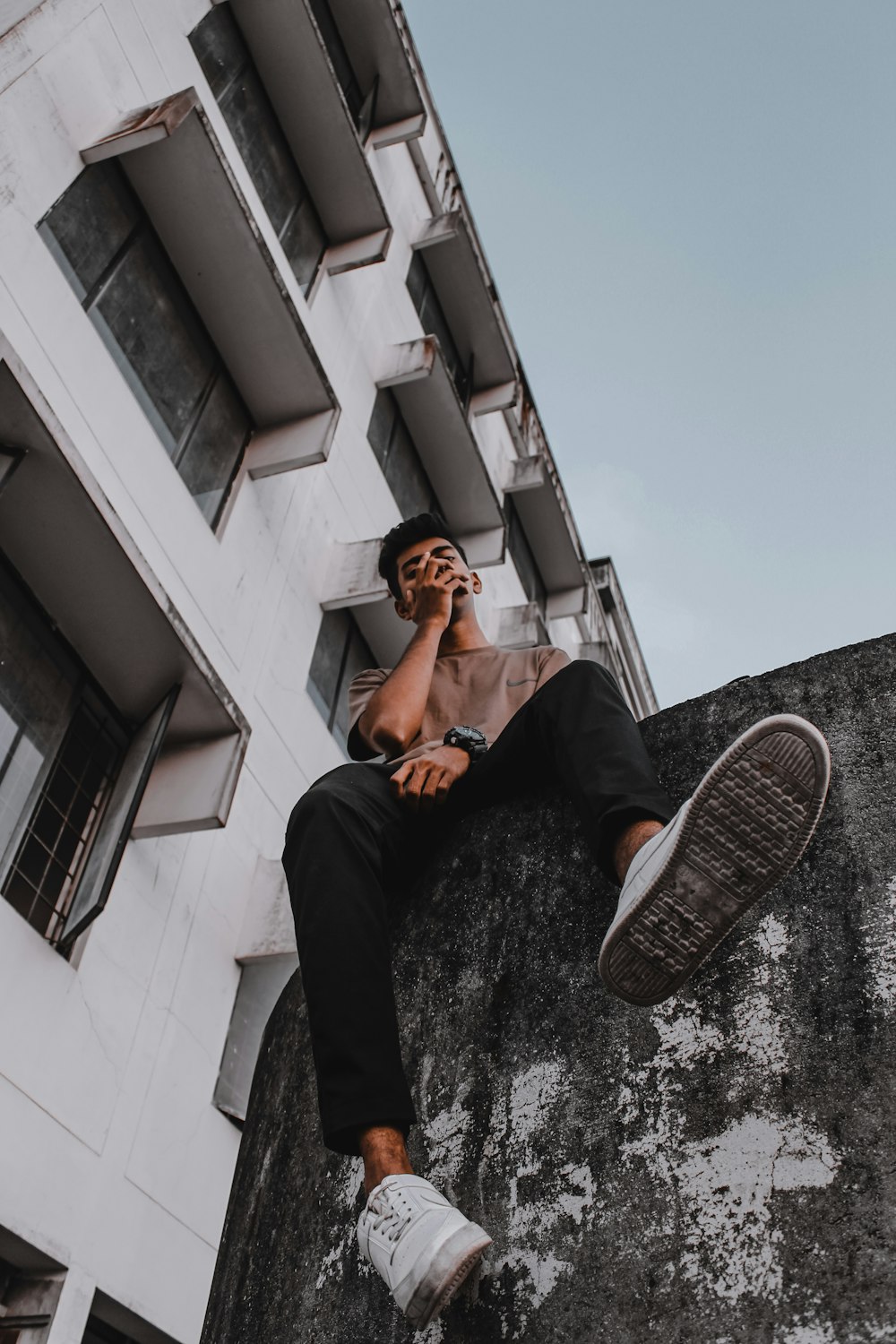 a man sitting on a ledge