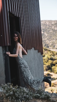 a person posing next to a zebra