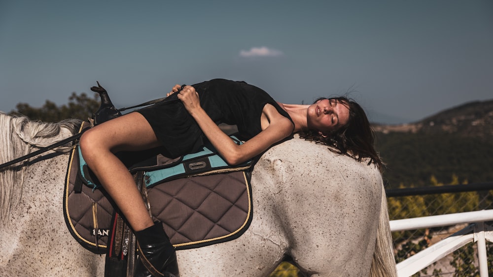 a woman riding a horse